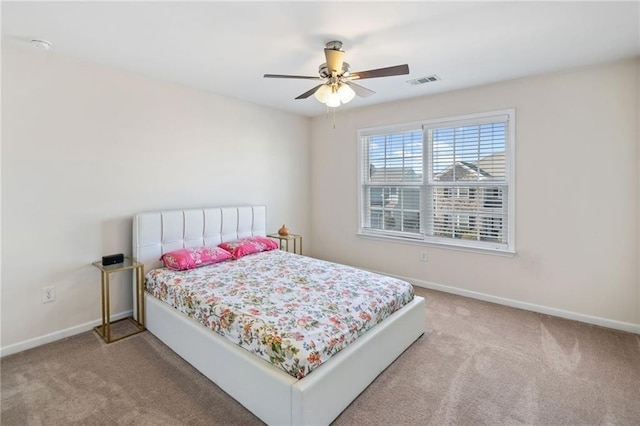 carpeted bedroom with baseboards and ceiling fan