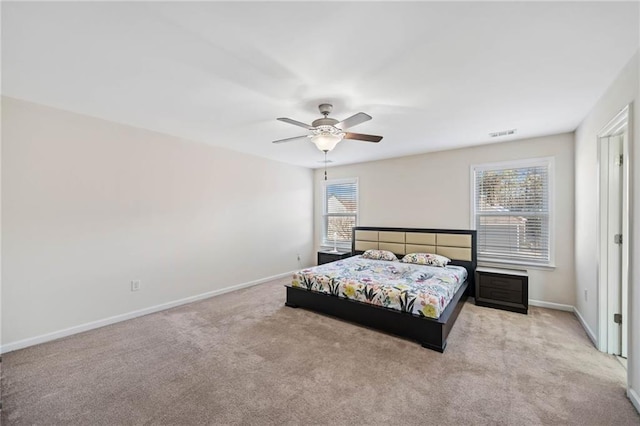 carpeted bedroom featuring baseboards and a ceiling fan