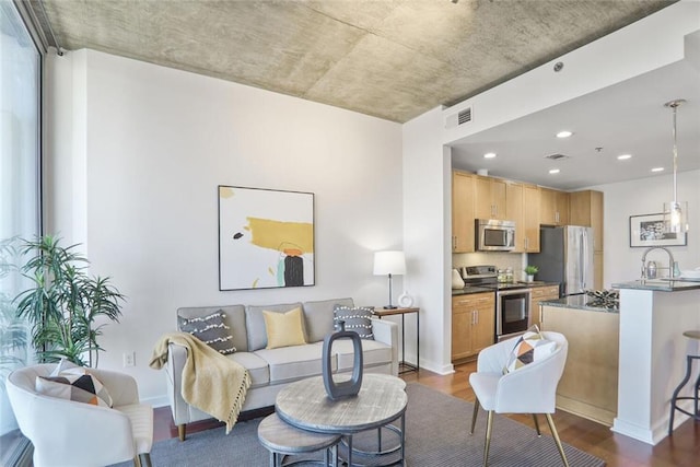 living room with recessed lighting, visible vents, baseboards, and dark wood-style flooring