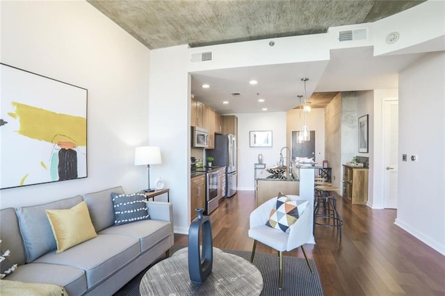 living area featuring dark wood-style floors, visible vents, and baseboards