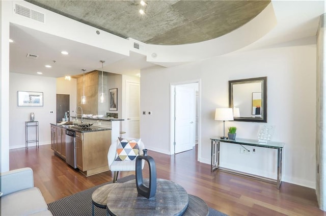 living area with visible vents, baseboards, and dark wood finished floors