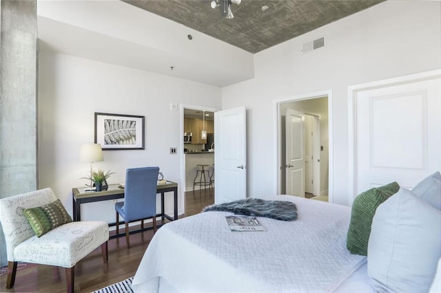 bedroom with wood finished floors and visible vents