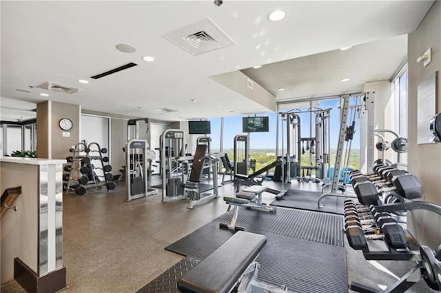 workout area featuring recessed lighting, visible vents, and floor to ceiling windows