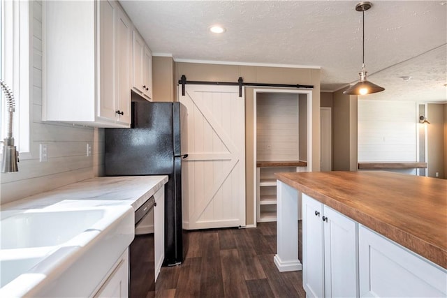 kitchen featuring wall chimney exhaust hood, black appliances, white cabinets, and a kitchen breakfast bar