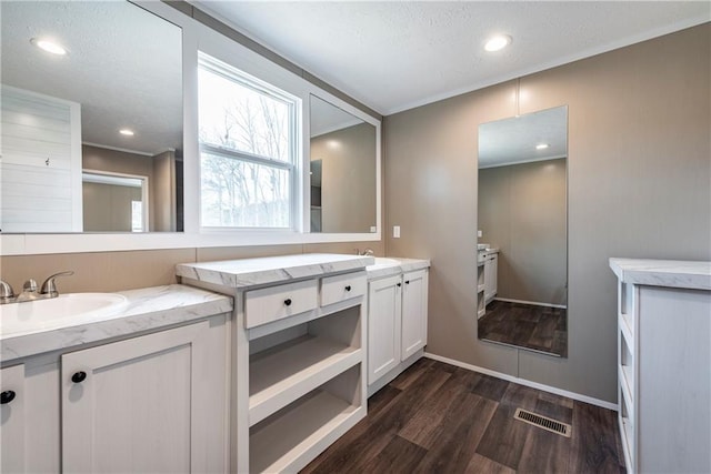 kitchen with electric range, a sink, backsplash, dishwasher, and wall chimney exhaust hood