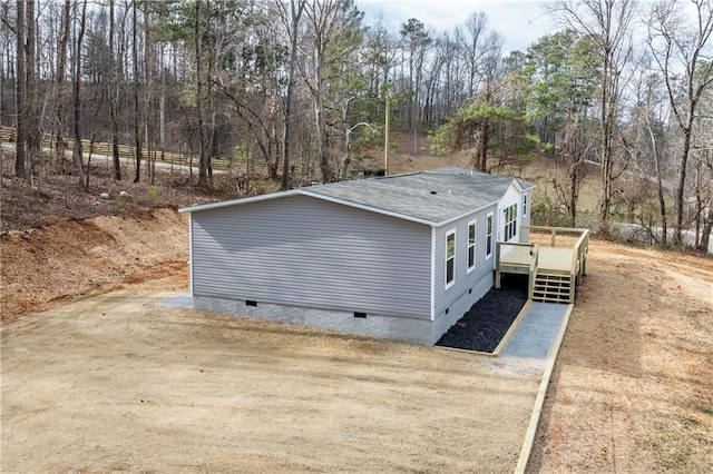 exterior space with dirt driveway, crawl space, and a wooden deck