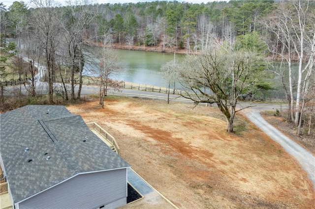 birds eye view of property with a water view and a view of trees