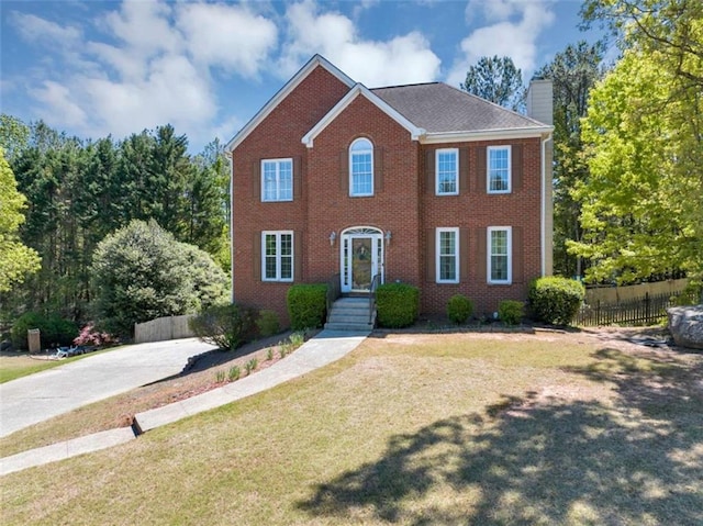 829 Verdun Way, Marietta, GA 30064 - colonial house featuring fence, a chimney, brick siding, and a front yard
