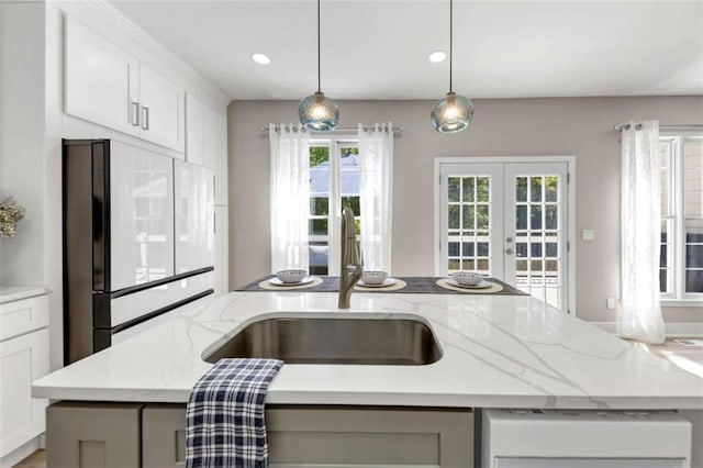 829 Verdun Way, Marietta, GA 30064 - kitchen featuring french doors, a sink, pendant lighting, light stone counters, and refrigerator