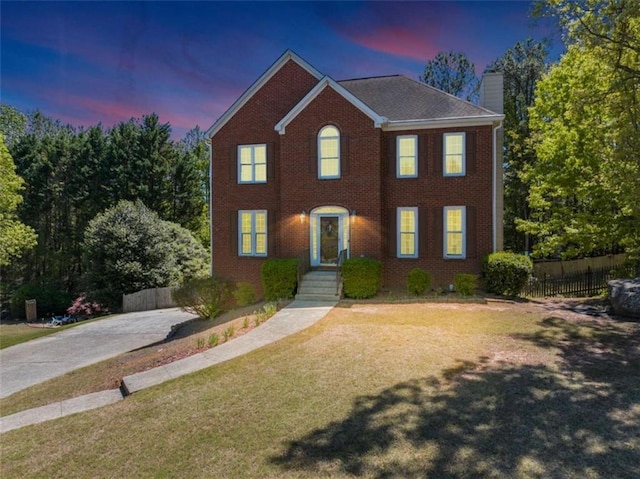 829 Verdun Way, Marietta, GA 30064 - colonial-style house featuring a front lawn, brick siding, a chimney, and fence