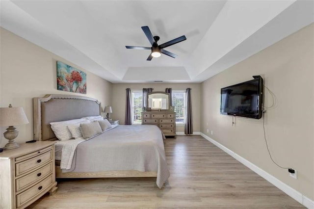 829 Verdun Way, Marietta, GA 30064 - bedroom with a raised ceiling, light wood-style flooring, a ceiling fan, and baseboards