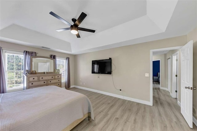 829 Verdun Way, Marietta, GA 30064 - bedroom featuring a tray ceiling, light wood-style floors, a ceiling fan, and baseboards