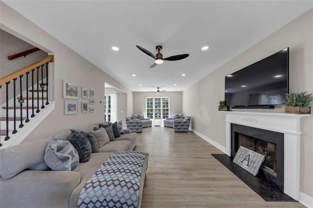 829 Verdun Way, Marietta, GA 30064 - living area featuring stairway, wood finished floors, a fireplace with flush hearth, ceiling fan, and recessed lighting