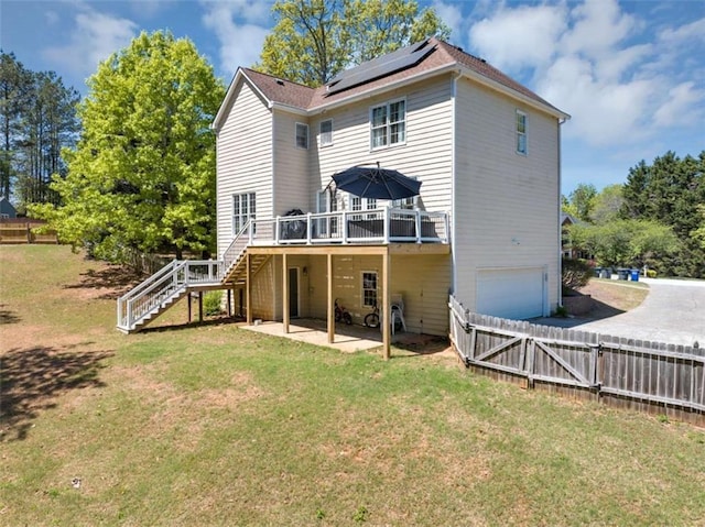 829 Verdun Way, Marietta, GA 30064 - back of property with stairway, roof mounted solar panels, a deck, a lawn, and a garage