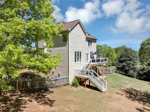 829 Verdun Way, Marietta, GA 30064 - back of property featuring a fenced backyard, stairway, a deck, and a lawn