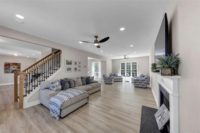 829 Verdun Way, Marietta, GA 30064 - living area featuring light wood finished floors, a fireplace with flush hearth, recessed lighting, a ceiling fan, and stairway