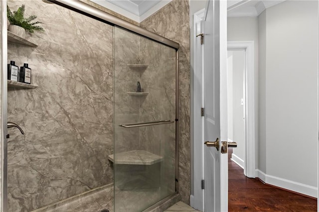 325 E Paces Ferry Rd NE Unit 703, Atlanta, GA 30305 - bathroom featuring a marble finish shower, crown molding, wood finished floors, and baseboards