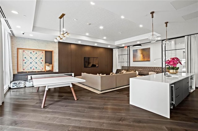 325 E Paces Ferry Rd NE Unit 703, Atlanta, GA 30305 - living room with a tray ceiling, dark wood-style floors, and recessed lighting