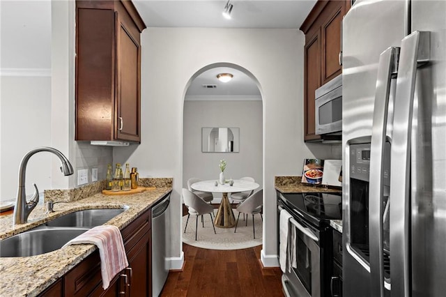 325 E Paces Ferry Rd NE Unit 703, Atlanta, GA 30305 - kitchen featuring stainless steel appliances, a sink, dark wood finished floors, light stone countertops, and crown molding