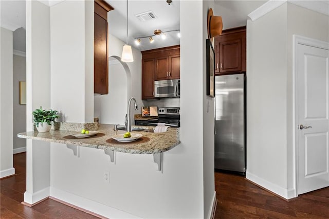 325 E Paces Ferry Rd NE Unit 703, Atlanta, GA 30305 - kitchen with stainless steel appliances, dark wood-type flooring, baseboards, and a kitchen breakfast bar