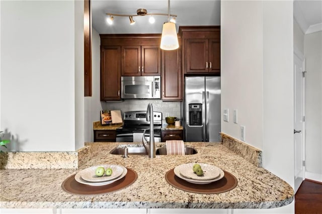 325 E Paces Ferry Rd NE Unit 703, Atlanta, GA 30305 - kitchen featuring stainless steel appliances, decorative backsplash, light stone countertops, hanging light fixtures, and dark brown cabinetry