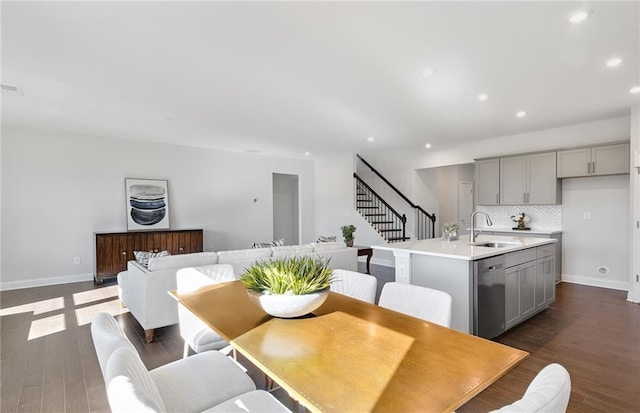 dining space featuring dark wood-type flooring and sink