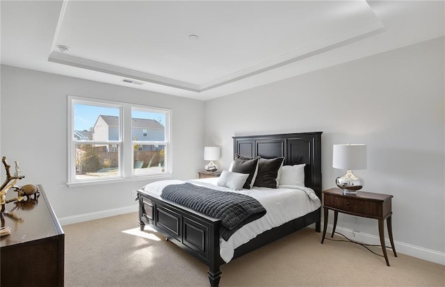 carpeted bedroom with a raised ceiling