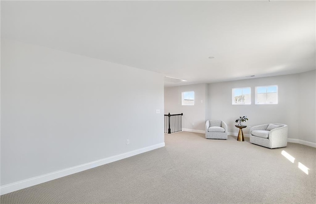 unfurnished room featuring light carpet