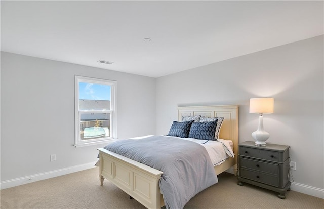 bedroom featuring light carpet