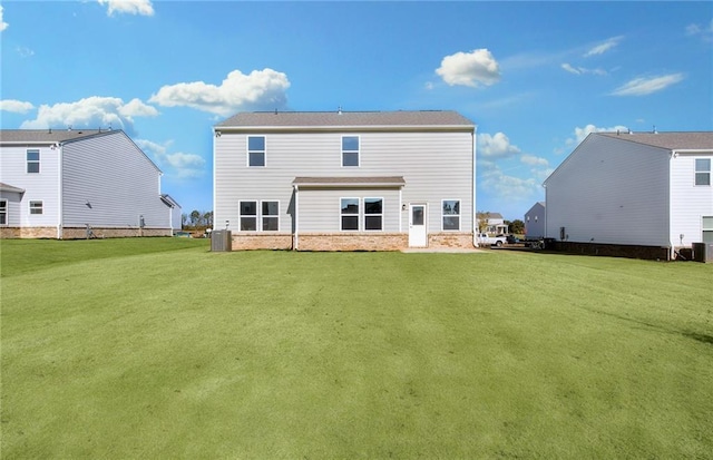 back of house featuring a lawn and central AC unit