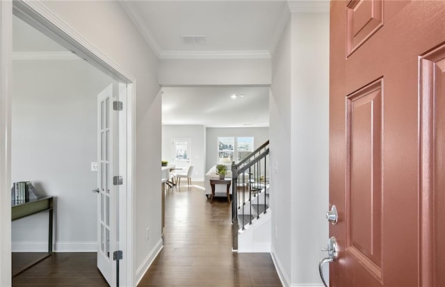 entryway featuring dark hardwood / wood-style floors and crown molding