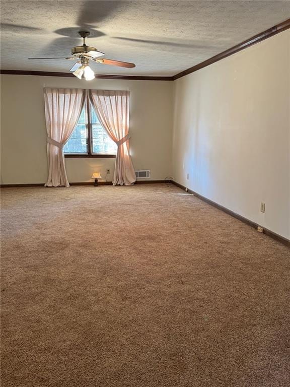 empty room featuring carpet, ceiling fan, crown molding, and a textured ceiling