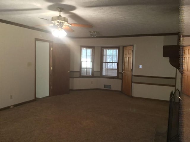 spare room featuring ceiling fan, carpet, and a textured ceiling