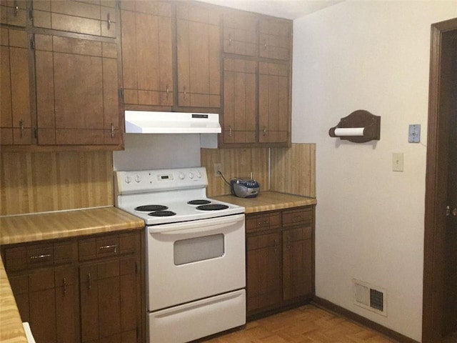 kitchen with white range with electric cooktop and light parquet floors