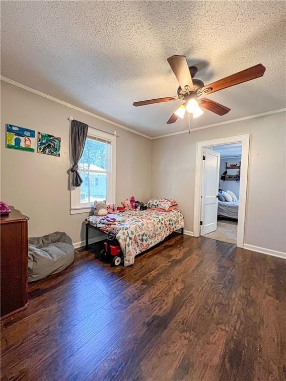 bedroom with dark hardwood / wood-style flooring, ceiling fan, ornamental molding, and a textured ceiling