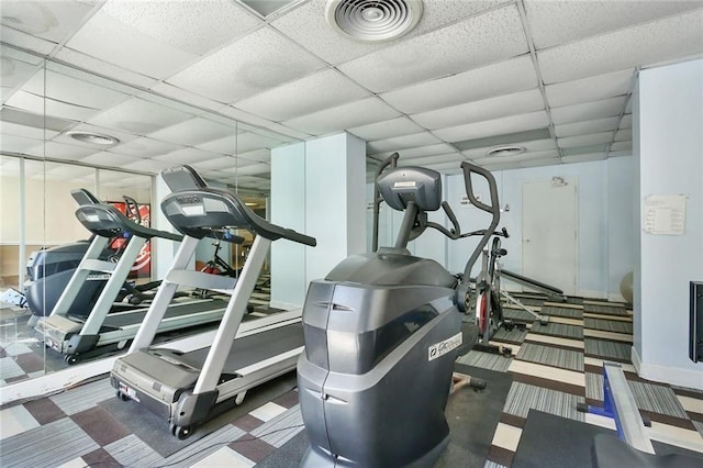 exercise room featuring a paneled ceiling