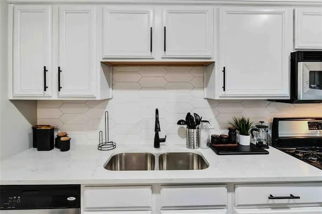 kitchen with dishwasher, white cabinetry, sink, and stainless steel gas range