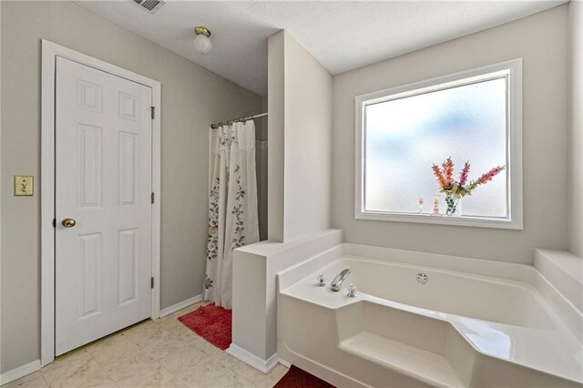 full bath with a garden tub, baseboards, and a shower with shower curtain