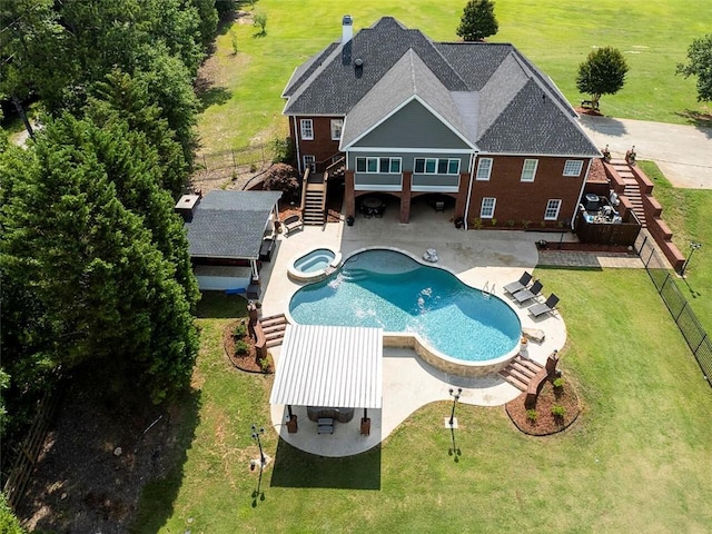 view of pool with a lawn, a patio area, and an in ground hot tub