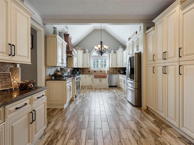 kitchen with an inviting chandelier, hanging light fixtures, backsplash, and stainless steel appliances