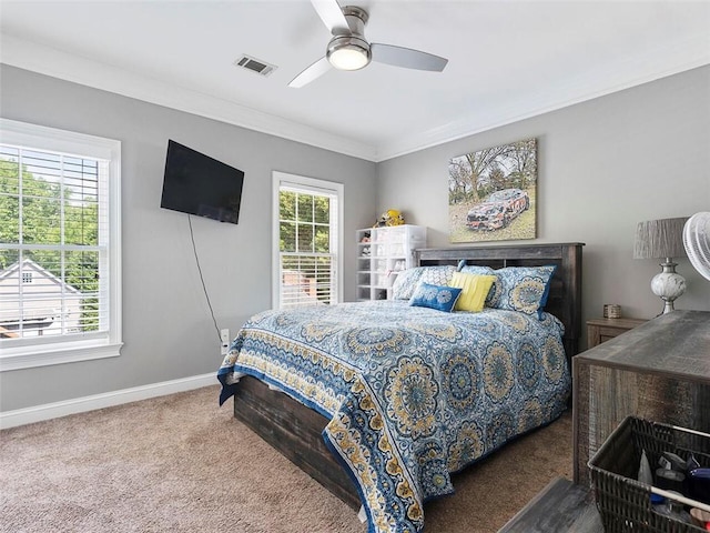 bedroom featuring dark colored carpet, ceiling fan, and crown molding