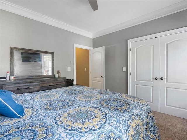 carpeted bedroom featuring a closet, ceiling fan, and ornamental molding