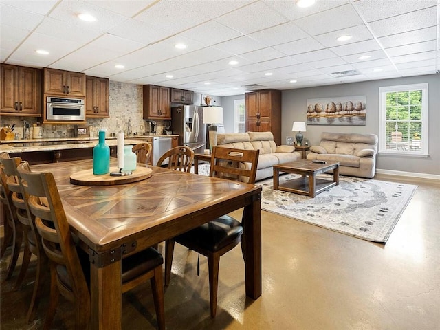 dining area featuring a paneled ceiling