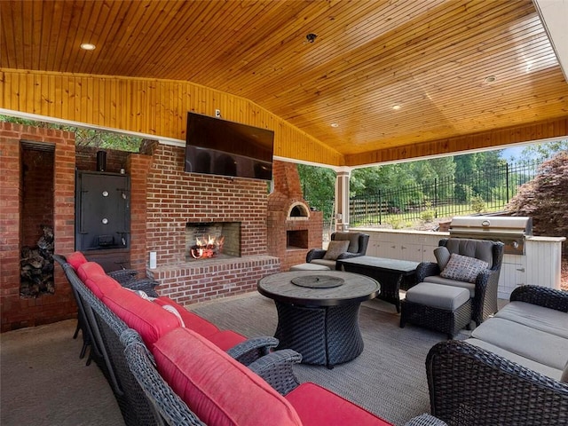 view of terrace with an outdoor living space with a fireplace and a grill