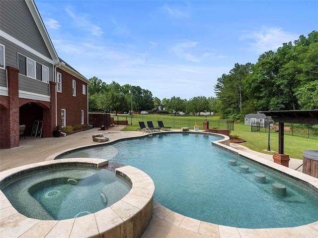 view of pool with a patio, a yard, and an in ground hot tub