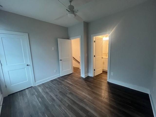 unfurnished bedroom with ceiling fan and dark hardwood / wood-style floors