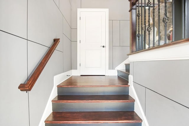 staircase with wood-type flooring