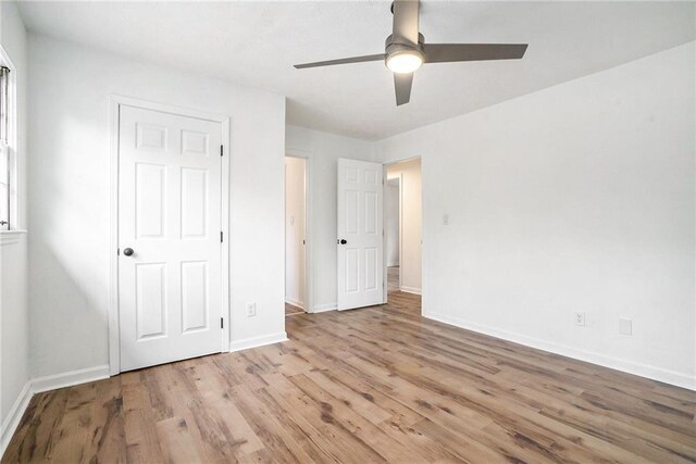 unfurnished bedroom featuring ceiling fan and light hardwood / wood-style floors