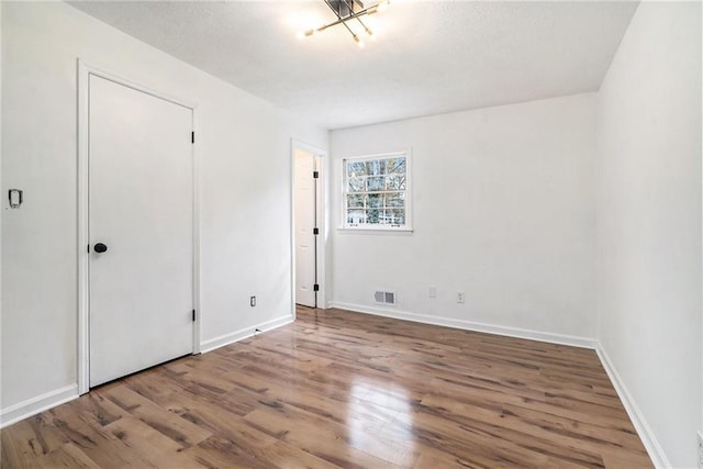 unfurnished bedroom with wood-type flooring