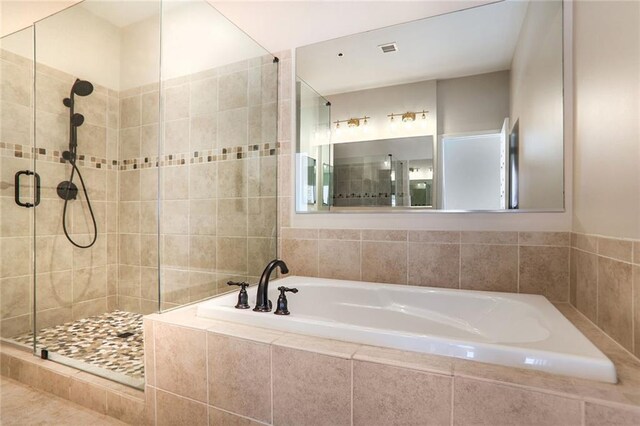 3820 Roswell Rd NE Unit 317, Atlanta, GA 30342 - living room featuring a tray ceiling, light tile patterned floors, baseboards, and visible vents